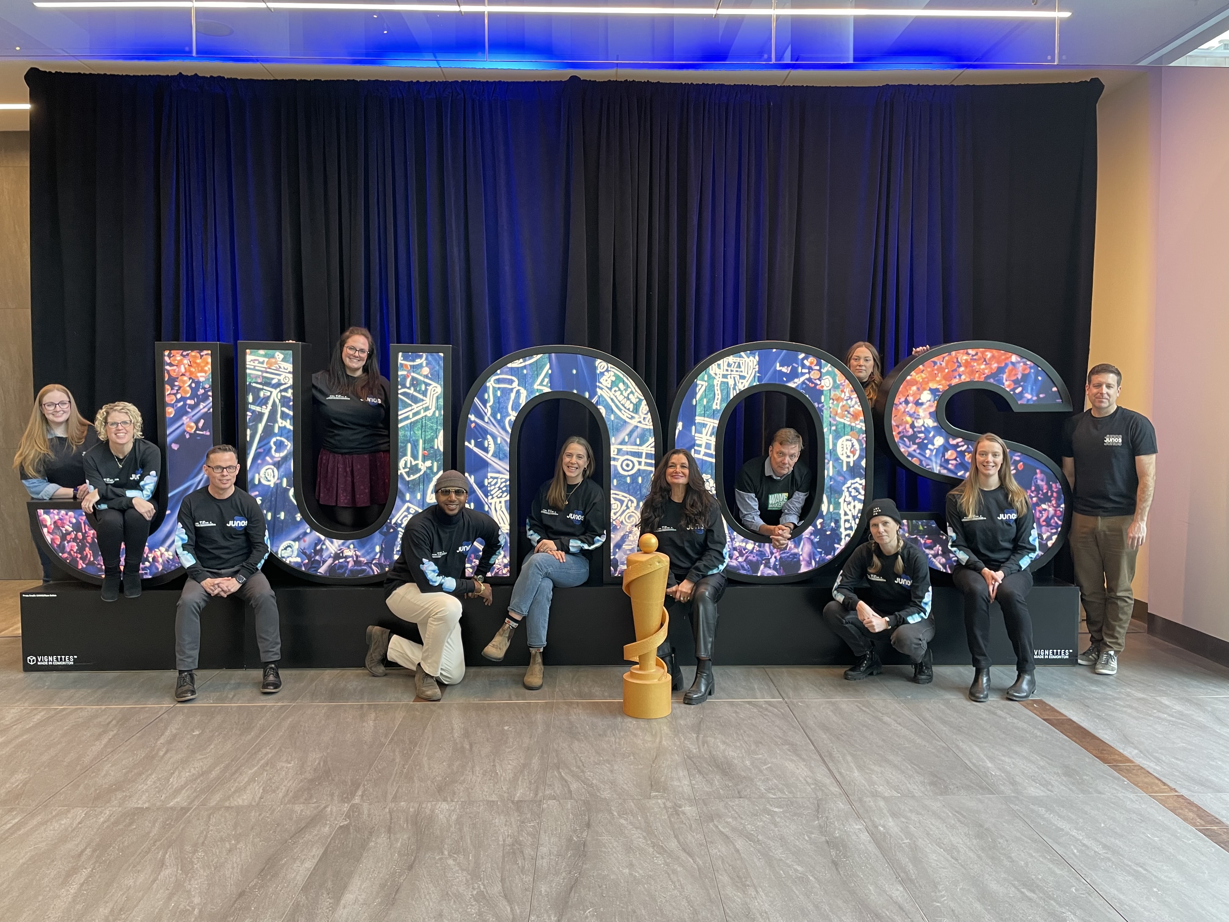 The 2024 JUNO Halifax Host Committee poses with the JUNO letters